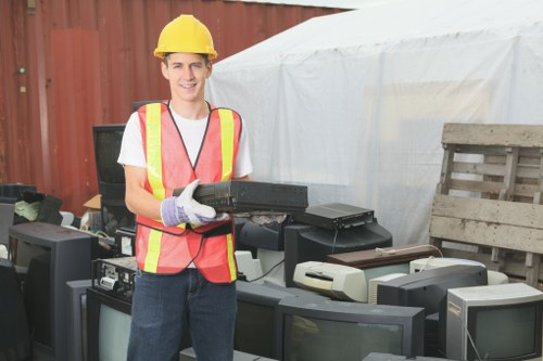 Workers wearing PPE and handling waste during an office clearance
